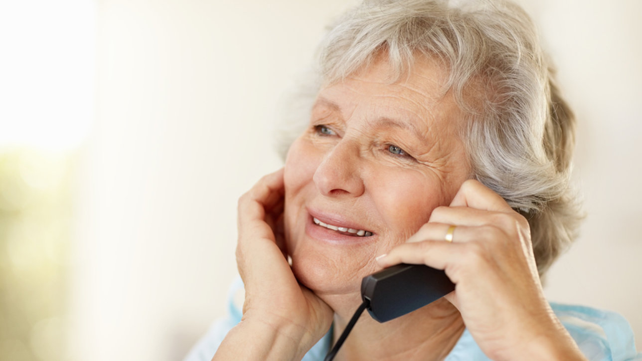 Closeup portrait of a mature woman using telephone - copyspace