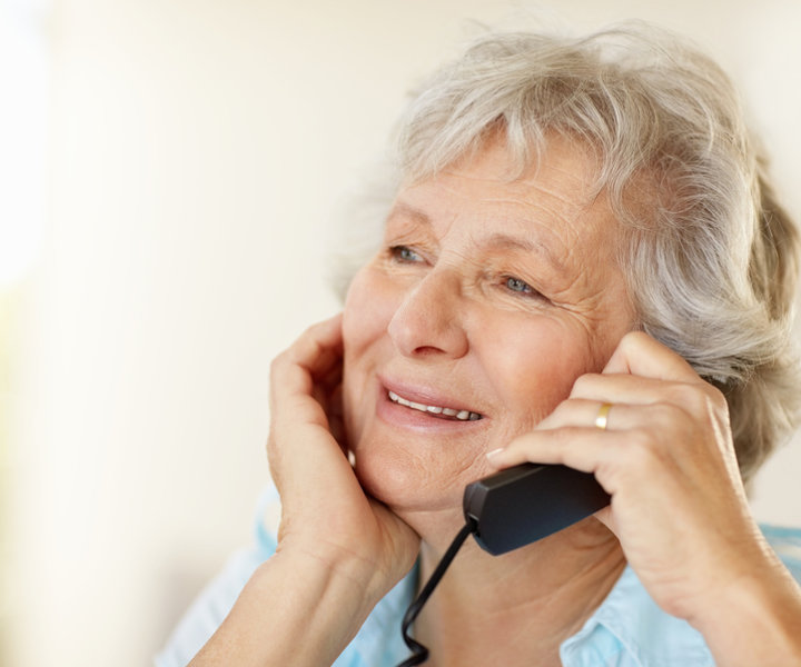 Closeup portrait of a mature woman using telephone - copyspace